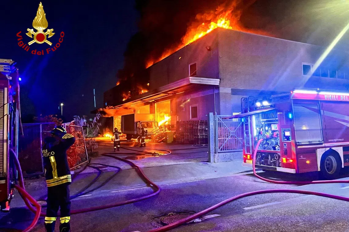 Italian fire brigade tackle a suspected arson attack on a Chinese business in the Tuscan city of Prato, Italy, in this handout photo obtained by Reuters. Vigili del Fuoco/Handout via REUTERS ATTENTION EDITORS – THIS IMAGE WAS PROVIDED BY A THIRD PARTY. WATERMARK PROVIDED AT SOURCE.