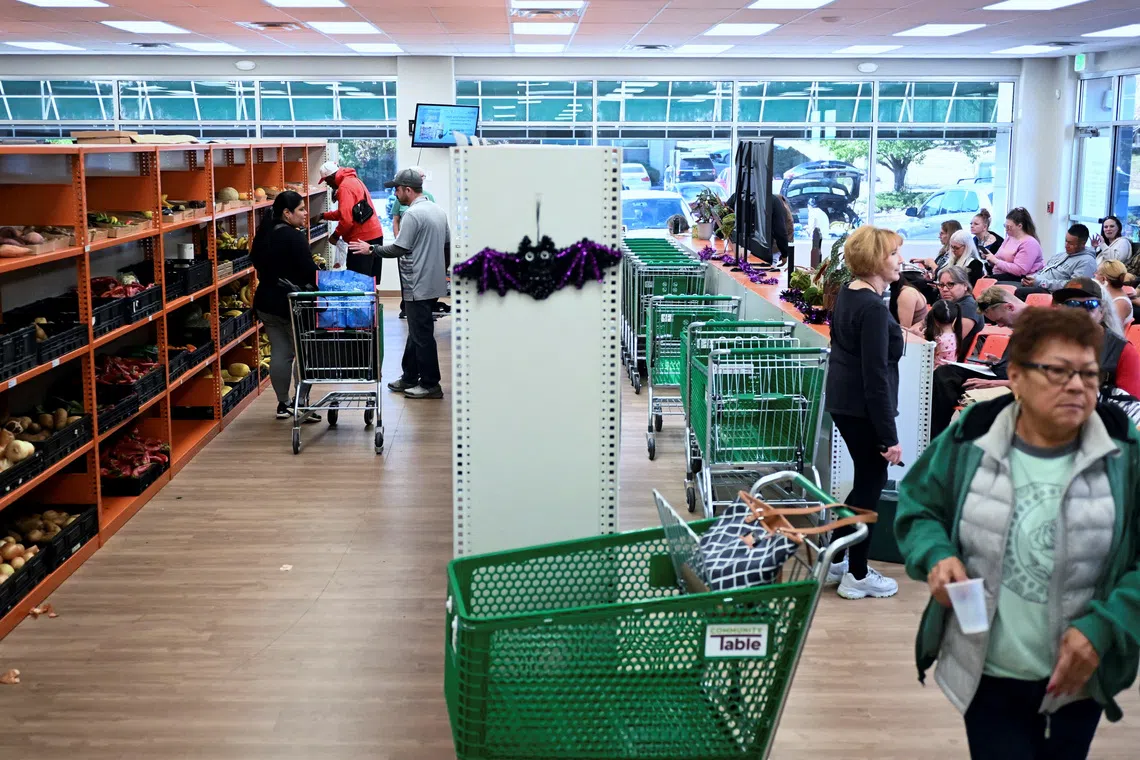 People select groceries at the Community Table food pantry, weeks into the continuing US government shutdown, in Arvada, Colorado, on Oct 22,