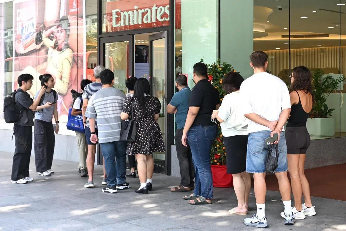 Emirates customers affected by the airspace closures across the Middle East queueing outside the airline's office on March 3.