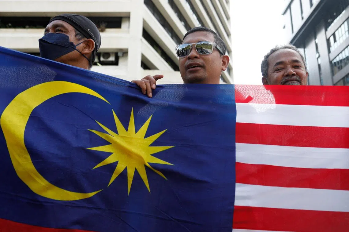 Mr Anwar Ibrahim's supporters celebrate his swearing in as Prime Minister outside the National Palace in Kuala Lumpur, on Nov 24.