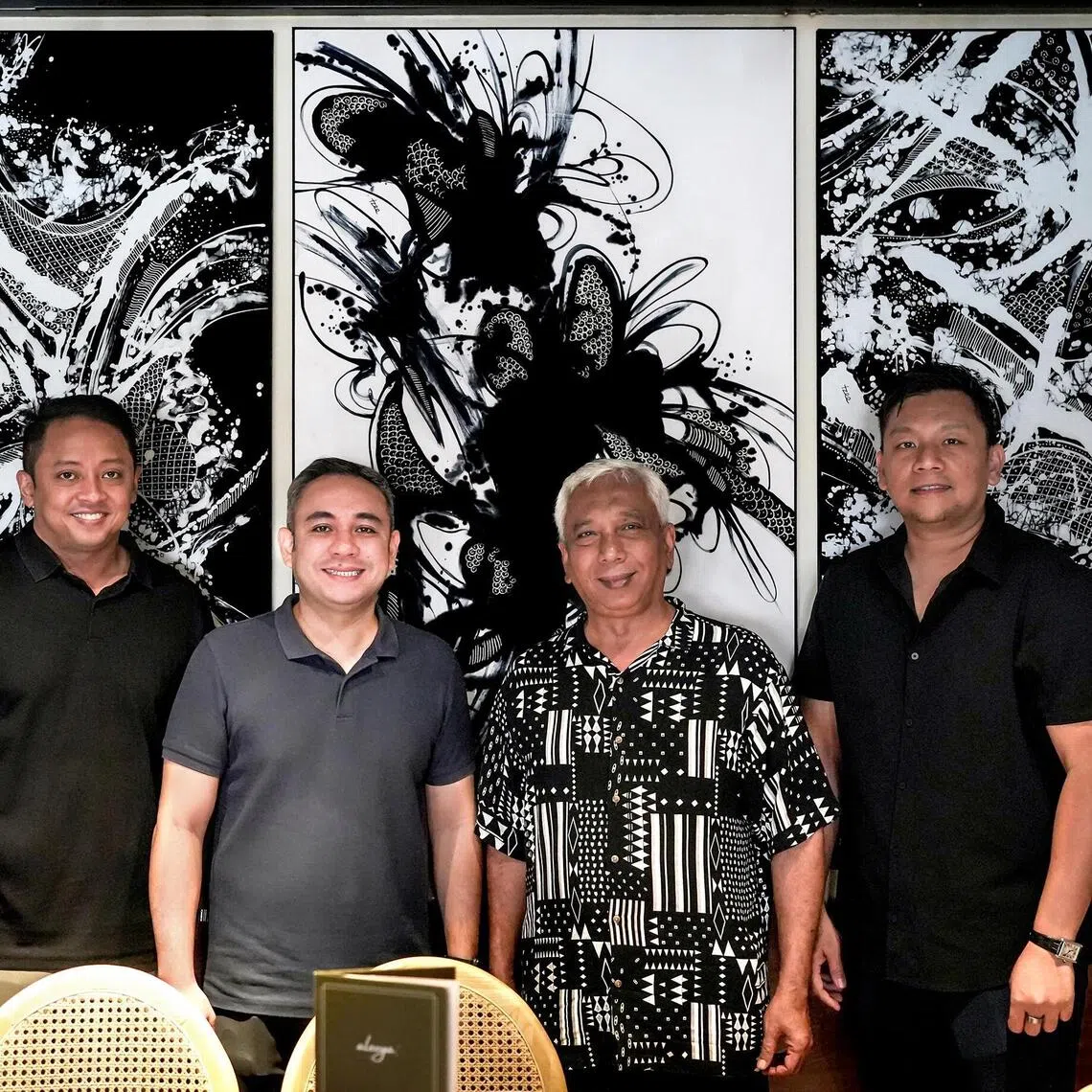 From left: Reza Ali, Najeeb Ali, Ika Sarkasi and Hairul Isa in front of works by Sarkasi Said. 