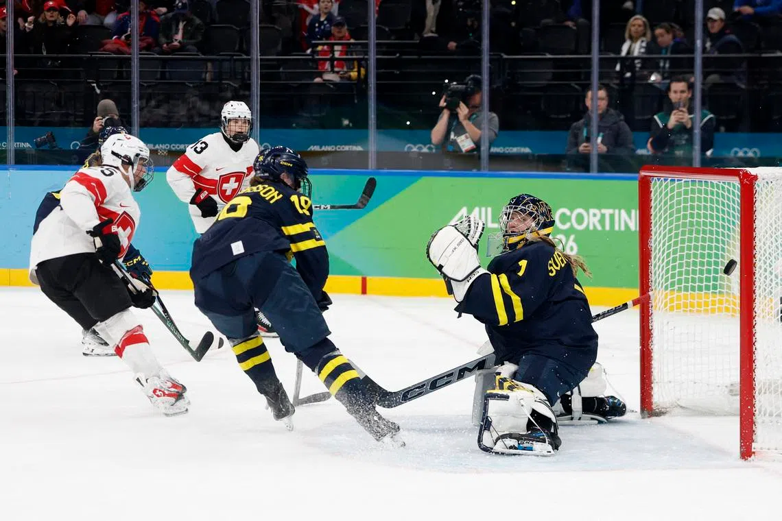 Milano Cortina 2026 Olympics - Ice Hockey - Women's Bronze Medal Game - Switzerland vs Sweden - Milano Santagiulia Ice Hockey Arena, Milan, Italy - February 19, 2026. Alina Muller of Switzerland scores their second goal past Ebba Svensson Traff of Sweden in overtime to win bronze REUTERS/David W Cerny