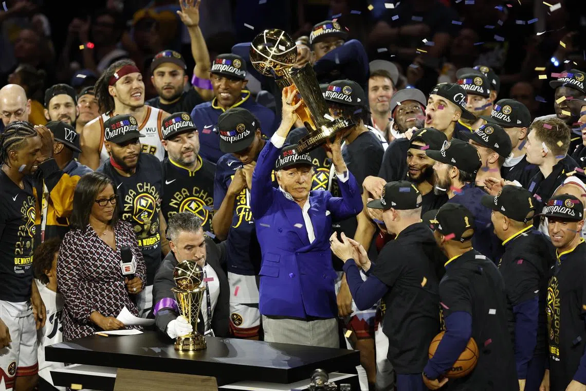 Denver Nuggets owner Stan Kroenke holding the NBA championship trophy after the Nuggets won game five of the NBA Finals against the Miami Heat at Ball Arena in Denver, Colorado.