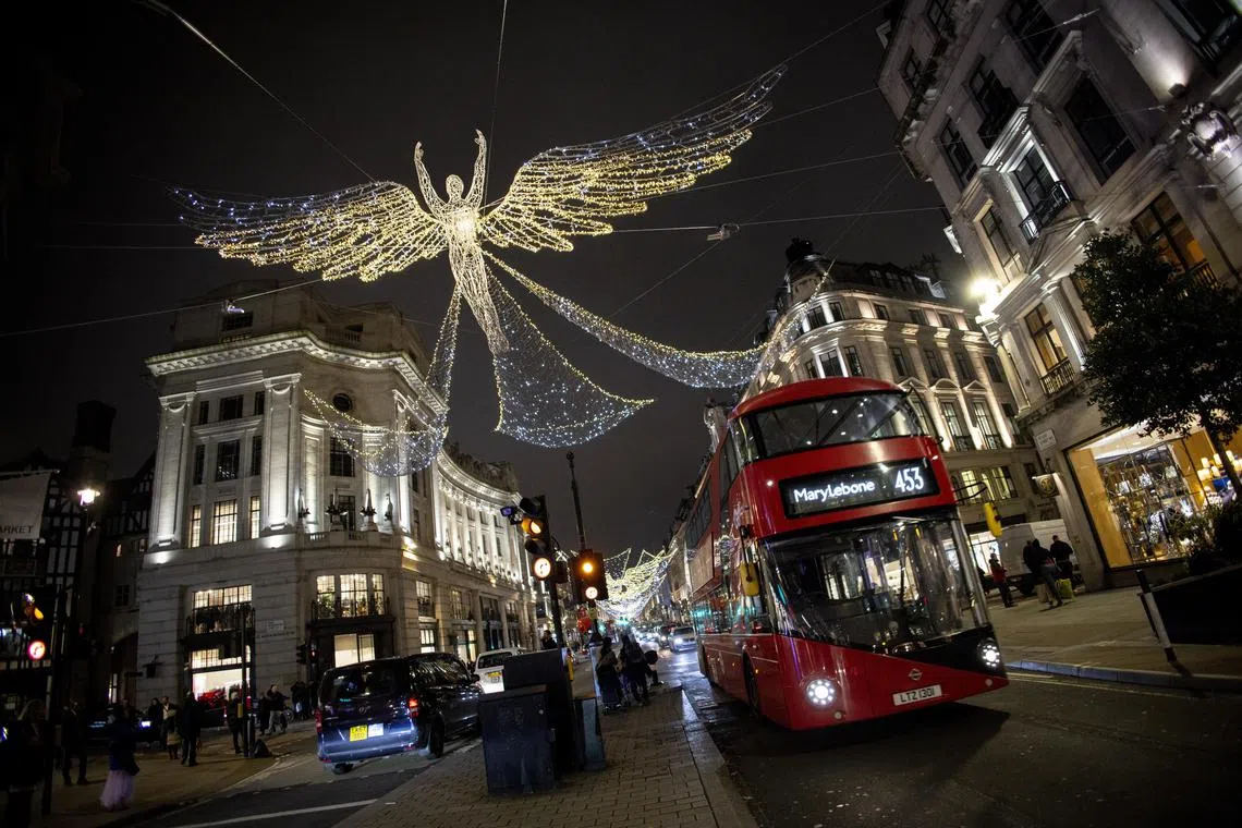 Shoppers and pedestrians pass under the Christmas lights on Oxford Street in London, Britain, 29 November 2022. Britain's National Grid Electricity System Operator (ESO) was considering activating its emergency blackout and asking households to reduce the amount of energy they use for the first time but it was avoided after more overseas electricity import was secured. 