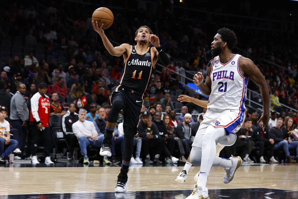 Trae Young of the Atlanta Hawks goes up for a shot as Joel Embiid of the Philadelphia 76ers defends during the second half at State Farm Arena on Nov 10, 2022.