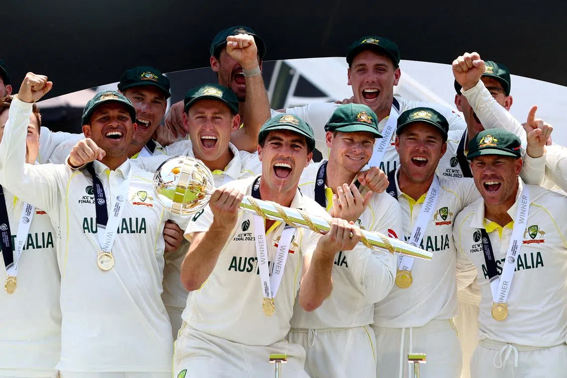 FILE PHOTO: Cricket - ICC World Test Championship Final - Australia v India - The Oval, London, Britain - June 11, 2023 Australia's Pat Cummins celebrates with the ICC Test Mace on the podium along with teammates after winning the World Test Championship final Action Images via Reuters/Paul Childs/File Photo