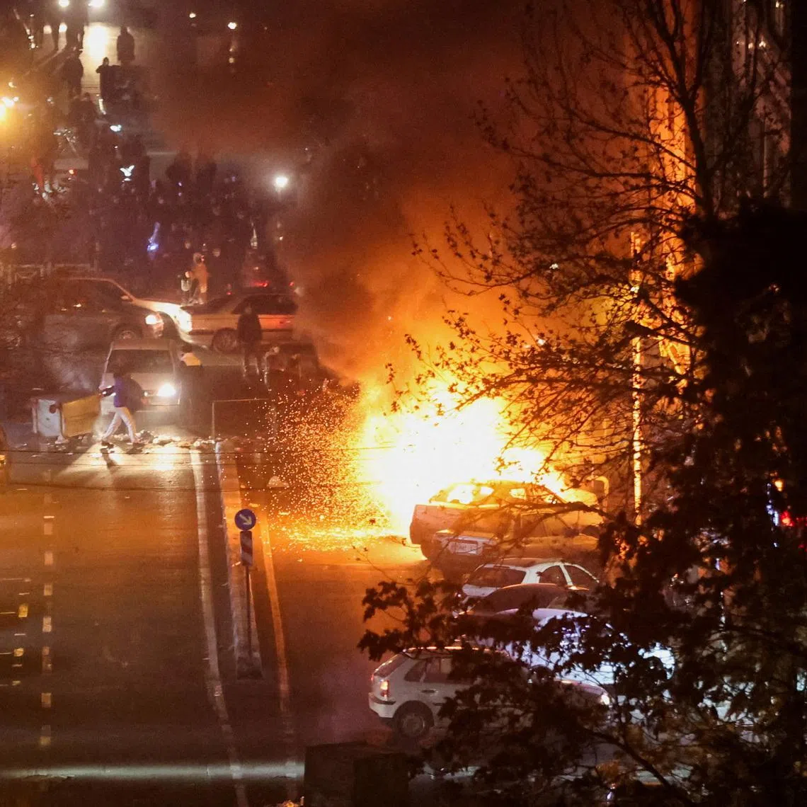 Cars burn in a street during a protest over the collapse of the currency's value, in Tehran, Iran, January 8, 2026. Stringer/WANA (West Asia News Agency) via REUTERS