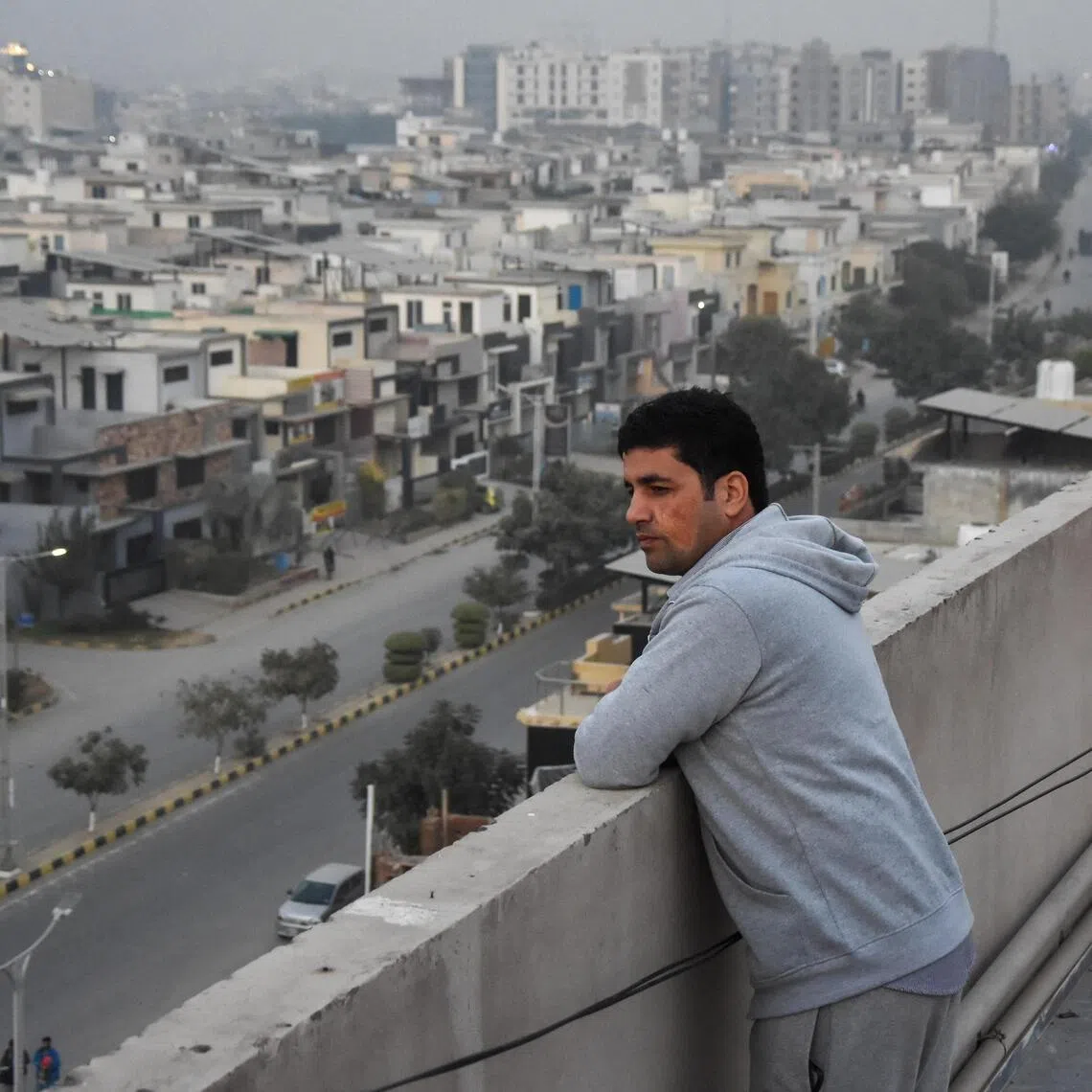 Ahmad Samim Naimi, 34, from Afghanistan's Panjshir province, who had worked as a TV presenter and press adviser, stands on the roof of his apartment building in Islamabad on Nov 28 after the US halted visa processing for Afghan nationals last week. 