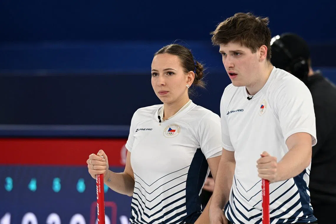 Milano Cortina 2026 Olympics - Curling - Mixed Doubles Round Robin Session 8 - South Korea vs Czech Republic - Cortina Curling Olympic Stadium, Cortina d'Ampezzo, Italy - February 07, 2026. Vit Chabicovsky of Czech Republic and Julie Zelingrova of Czech Republic look on during their match against Yeongseok Jeong of South Korea and Seonyeong Kim of South Korea REUTERS/Jennifer Lorenzini
