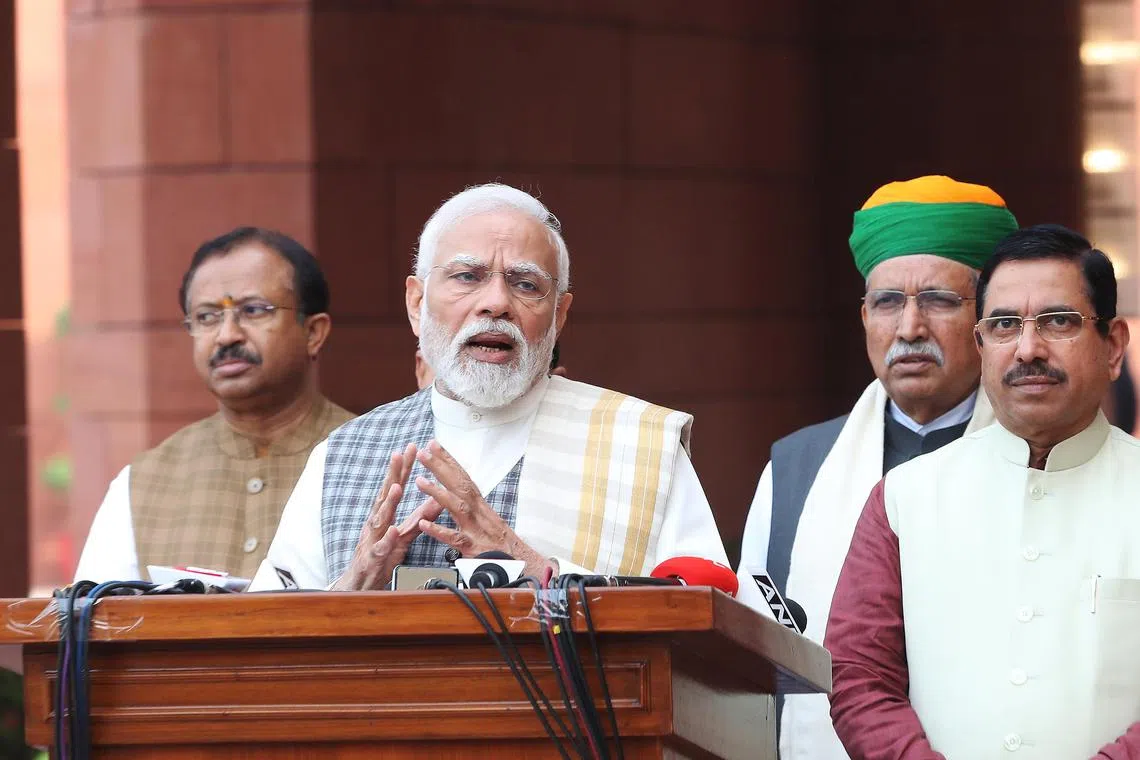PM Narendra Modi (second, left) talks to the media at the new Parliament House building in New Delhi,  on Dec 4, 2023.