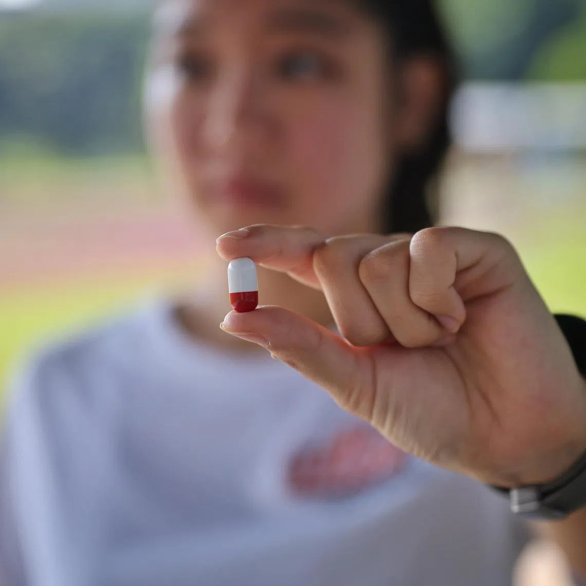 ST20231103_202364561153/ocpill03/Osmond Chia/Jason Quah
Photo illustration of a runner holding a pill that measures temperature. Pic taken on 3 Nov, 2023.
//
Runners are popping pills that measure the precise core temperature to help ensure sportsmen aren't overexerting during their workouts. NUS and Samsung have tested the pill-sized trackers, which runners ingest, during marathons to build a sizeable database for the project.The study aims to improve the accuracy of temperature readings measured on the skin's surface by smartwatches and other wearables, which can in turn help to monitor seniors' health and build predictive technology for heat injury cases.