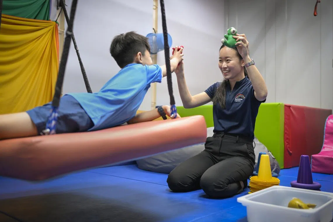 In Rainbow Centre’s occupational therapy room, Ms Lim Yu Jie helps students improve their ability in daily tasks through play-based activities.
