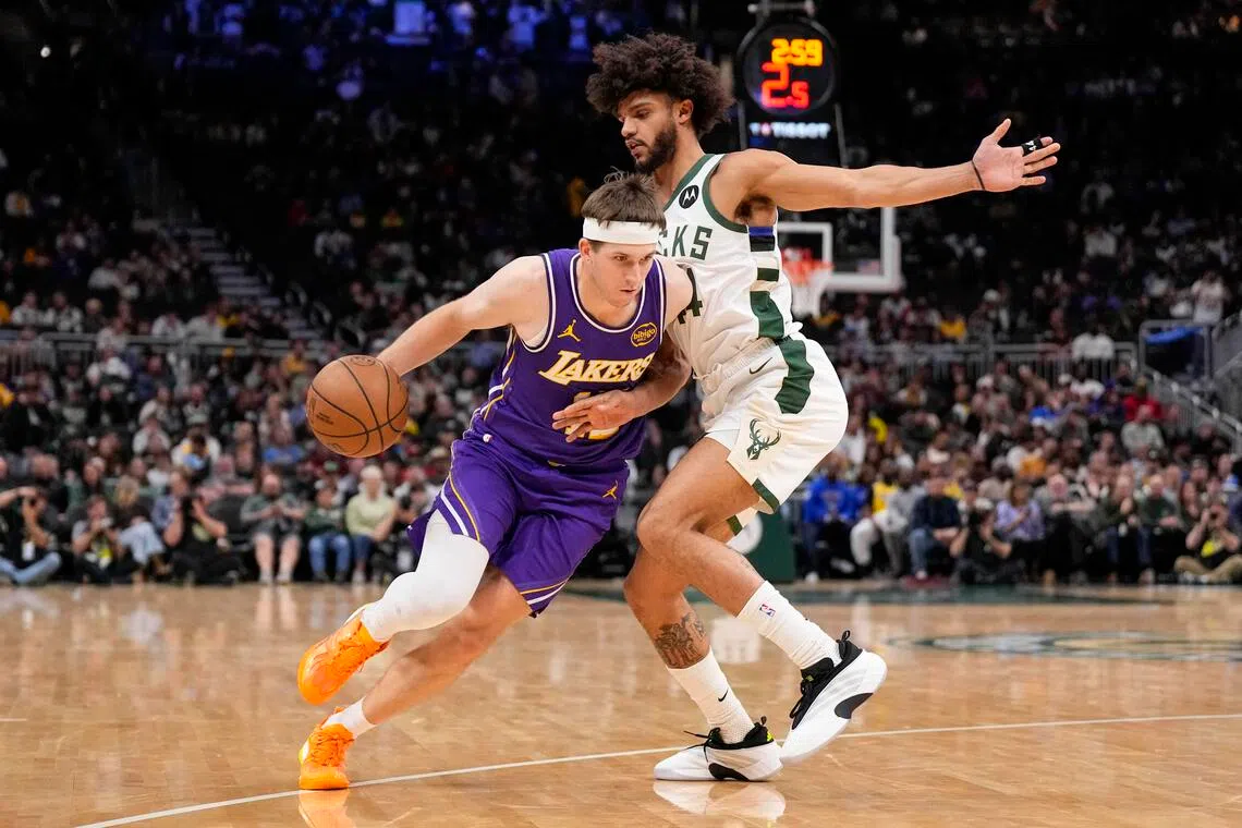 Los Angeles Lakers guard Austin Reaves drives towards the basket against Milwaukee Bucks guard Andre Jackson Jr. during the fourth quarter at Fiserv Forum.