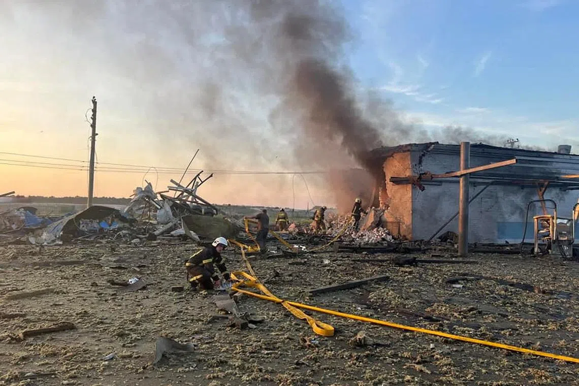 Firefighters work at a site of a car wash heavily damaged by a Russian missile strike in Ukraine on June 9.