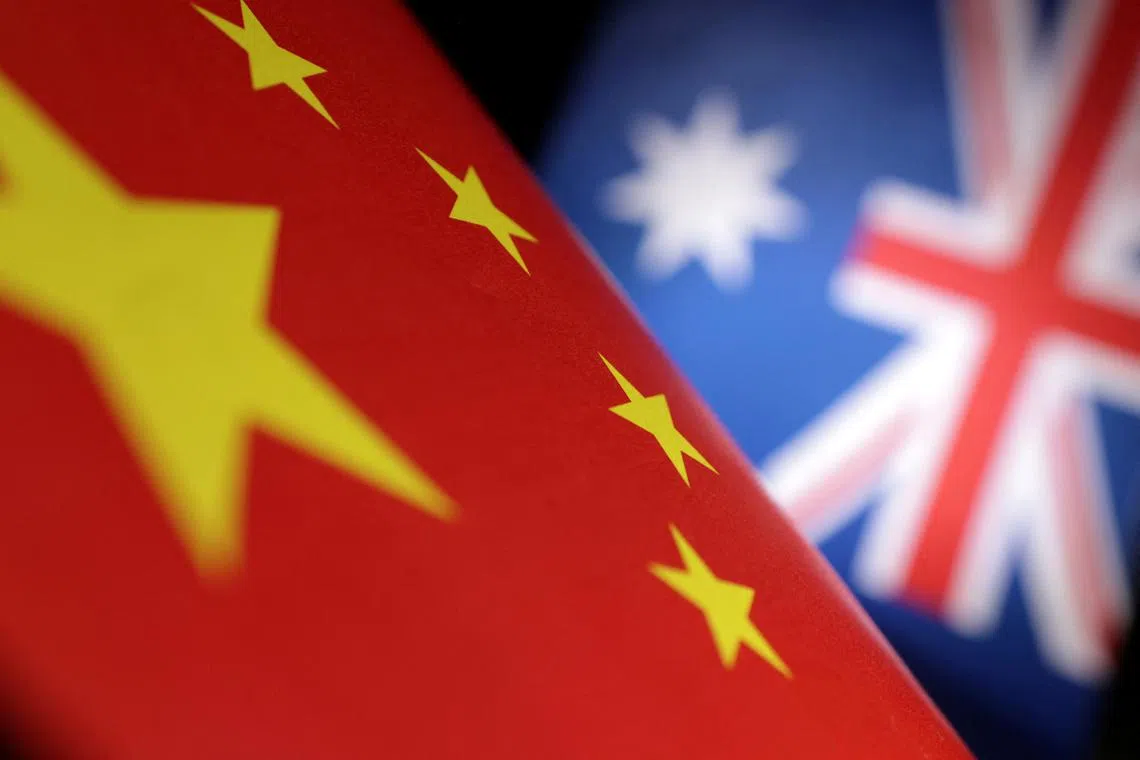 Printed Chinese and Australian flags are seen in this illustration, July 21, 2022. REUTERS/Dado Ruvic/Illustration/ File Photo