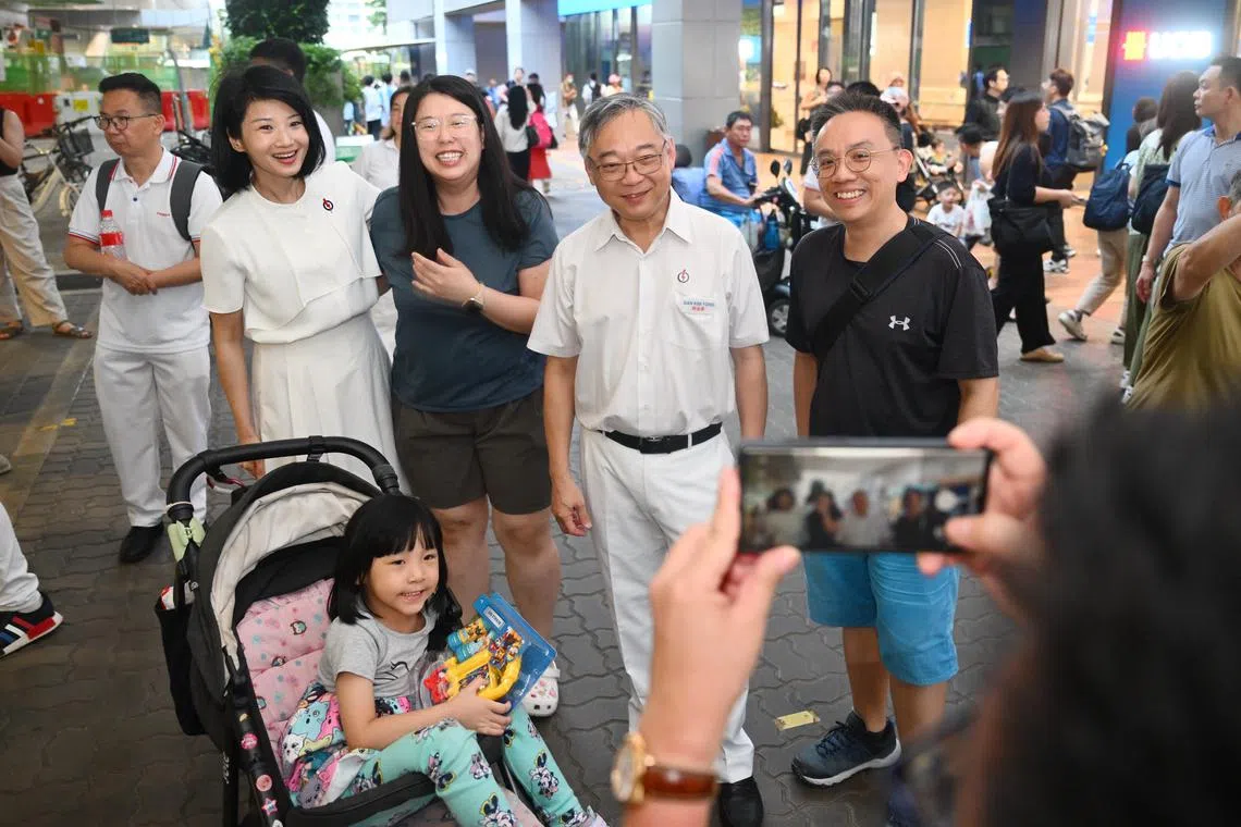 DPM Gan Kim Yong (second right) with Ms Sun Xueling mingling with residents during a walkabout on April 23.