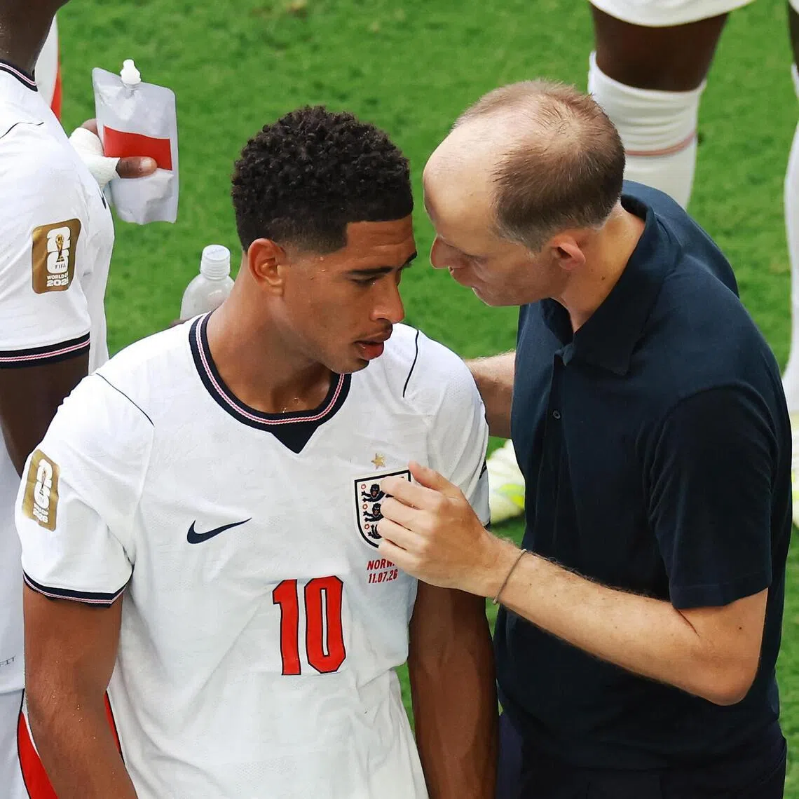 England manager Thomas Tuchel speaking to midfielder Jude Bellingham during a hydration break in their July 11 World Cup quarter-final match against Norway.