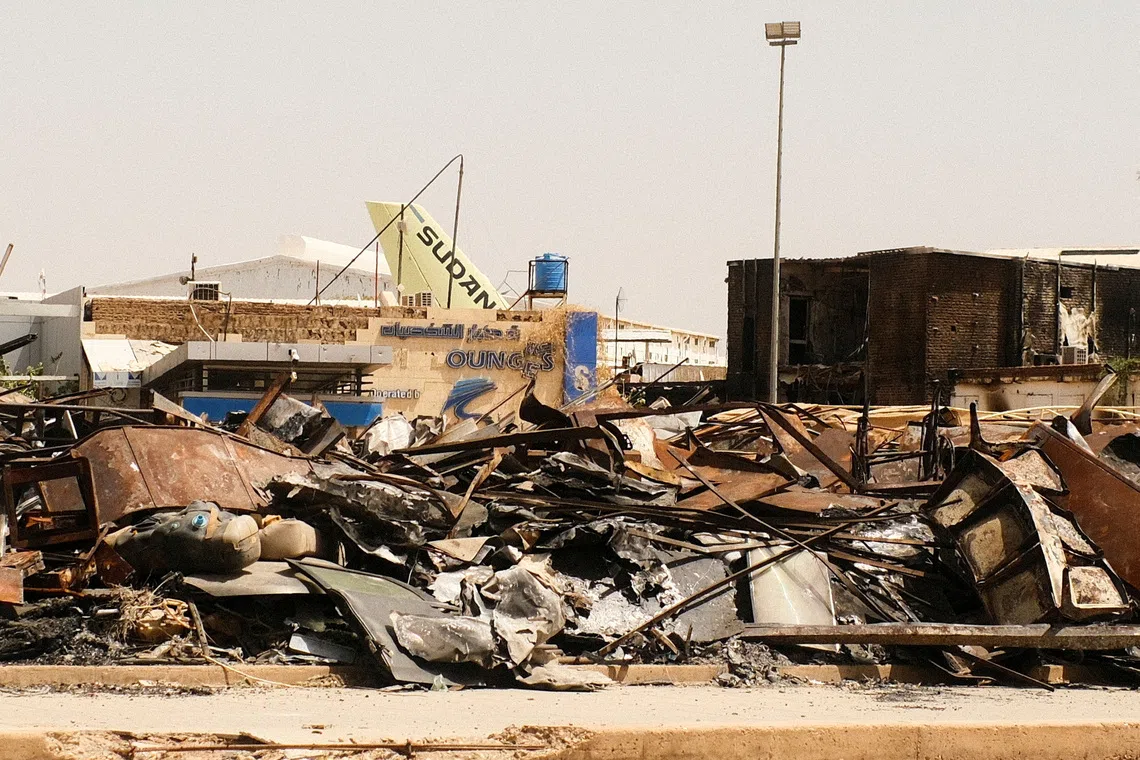 FILE PHOTO: A view of a burned building and the tail of a Sudan Airways aircraft amid debris at Khartoum Airport, after the Sudanese army deepened its control over Khartoum from the Rapid Support Forces (RSF), in Khartoum Sudan April 26, 2025. REUTERS/El Tayeb Siddig/File Photo