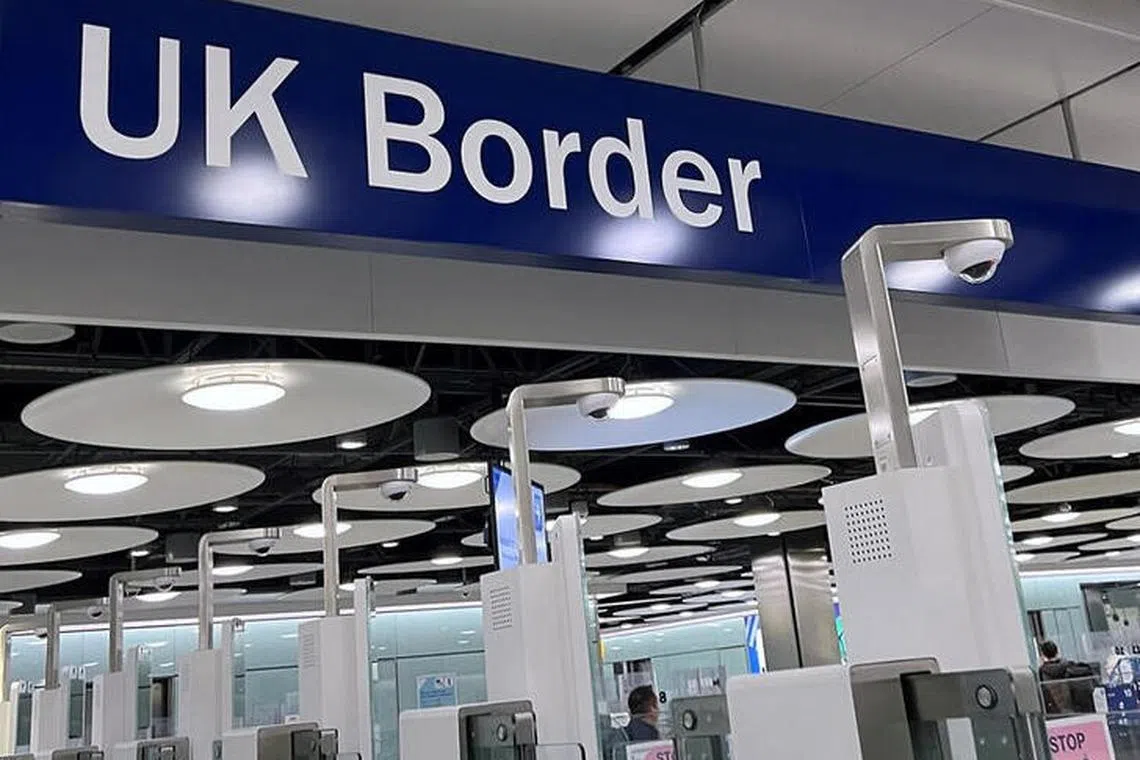 A sign is seen at the arrivals passport control area of Terminal 5, at Heathrow Airport, London, Britain, March 23, 2023. REUTERS/Toby Melville/files