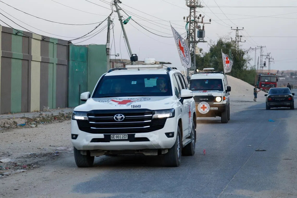Red Cross vehicles transporting the bodies of two deceased hostages, kidnapped during the Oct 7, 2023, attack on Israel by Hamas.