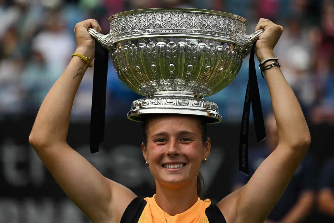 Daria Kasatkina lifts the trophy after beating Canada's Leylah Fernandez in the  Eastbourne final.