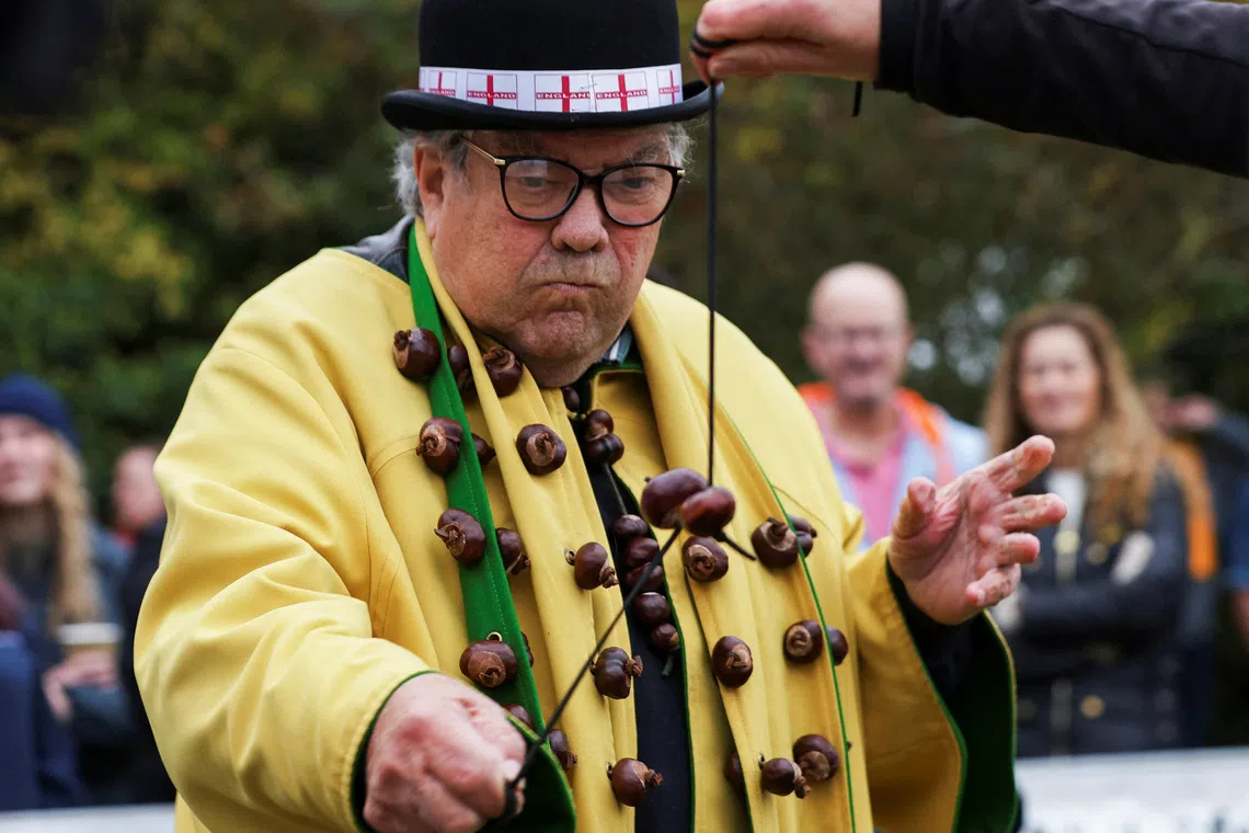 David Jakins, known as 'King Conker', takes part in the annual World Conker Championships in Southwick, Britain, October 12, 2025. REUTERS/Temilade Adelaja