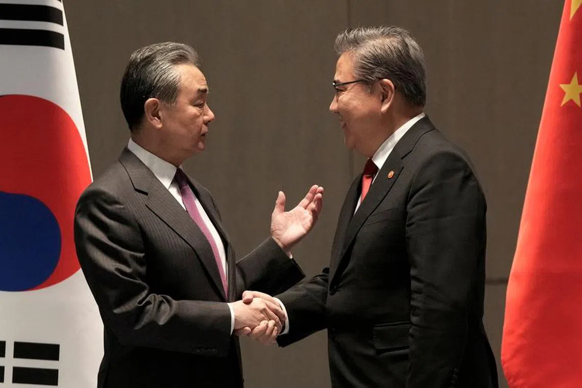 South Korean Foreign Minister Park Jin, right, talks with his Chinese counterpart Wang Yi prior to a meeting in Busan, South Korea, Sunday, Nov. 26, 2023. Ahn Young-joon/Pool via REUTERS
