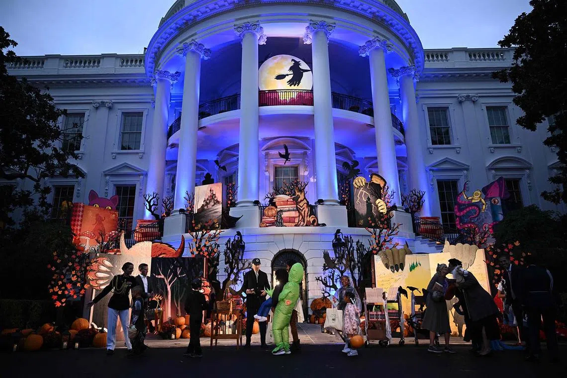 US President Joe Biden and US First Lady Jill Biden hand out candy to children during a Halloween celebration on the South Lawn of the White House in Washington, DC, on Oct 30.