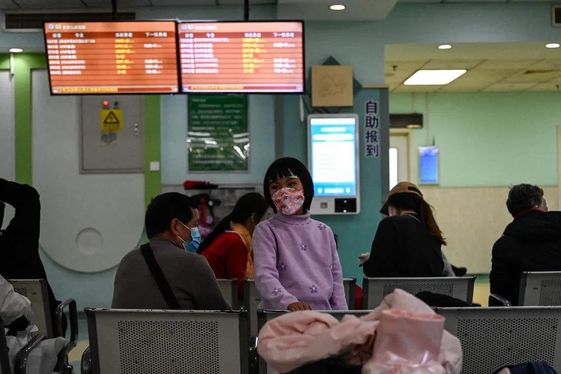 Children and their parents wait at an outpatient area at a children hospital in Beijing on Nov 23, 2023. 