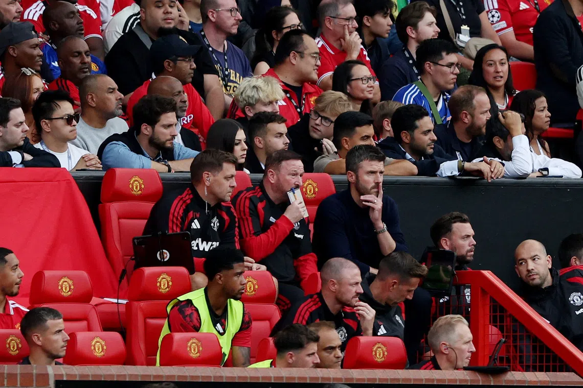 Soccer Football - Premier League - Manchester United v Manchester City - Old Trafford, Manchester, Britain - September 13, 2026 Manchester United manager Michael Carrick with assistant manager Steve Holland and assistant coach Jonathan Woodgate REUTERS/Scott Heppell