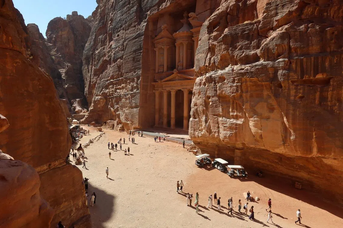FILE PHOTO: Visitors walk near the treasury site in the ancient city of Petra, Jordan, October 29, 2024. REUTERS/Jehad Shelbak/File photo