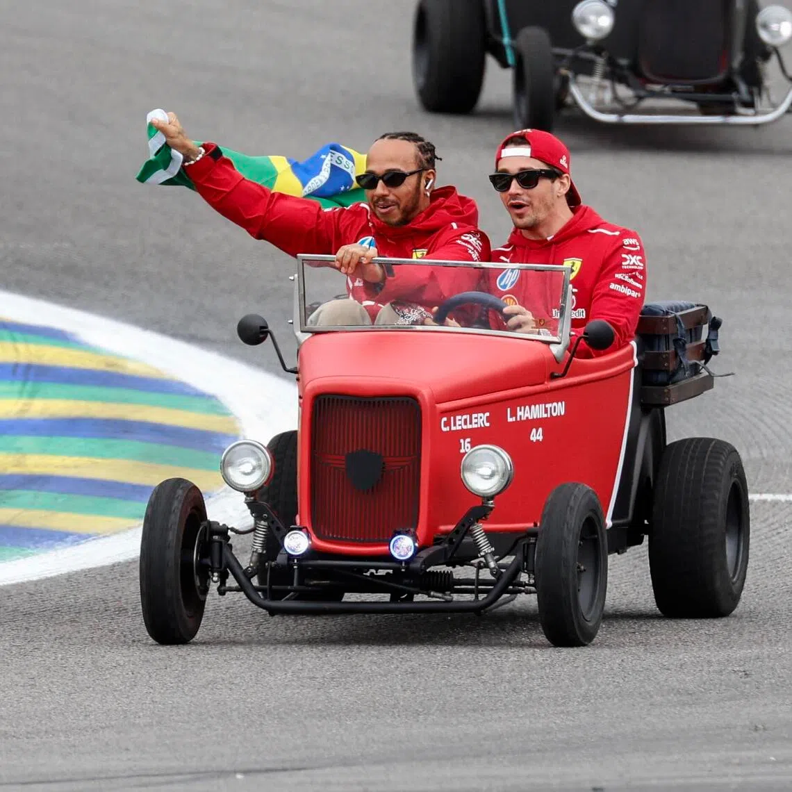 Charles Leclerc and Lewis Hamilton of Ferrari participate in a drivers parade prior to the 2025 Sao Paulo Grand Prix.