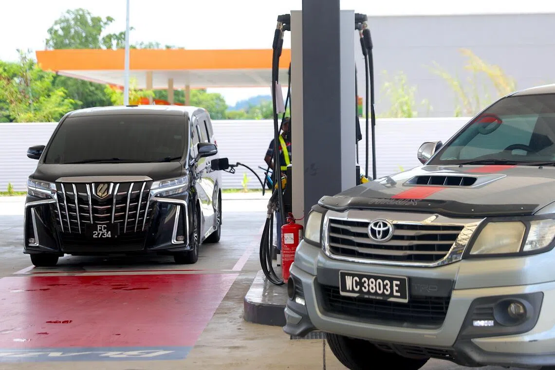 A vehicle is refilled at a petrol station in Port Dickson on March 25, 2026. The  government is spending about RM4 billion (S$1.28 billion) a month to absorb the surge in global oil prices following the outbreak of the Iran war on Feb 28. 