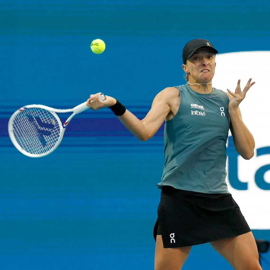 Iga Swiatek hitting a forehand against Magda Linette on day three of the 2026 Miami Open at Hard Rock Stadium. 