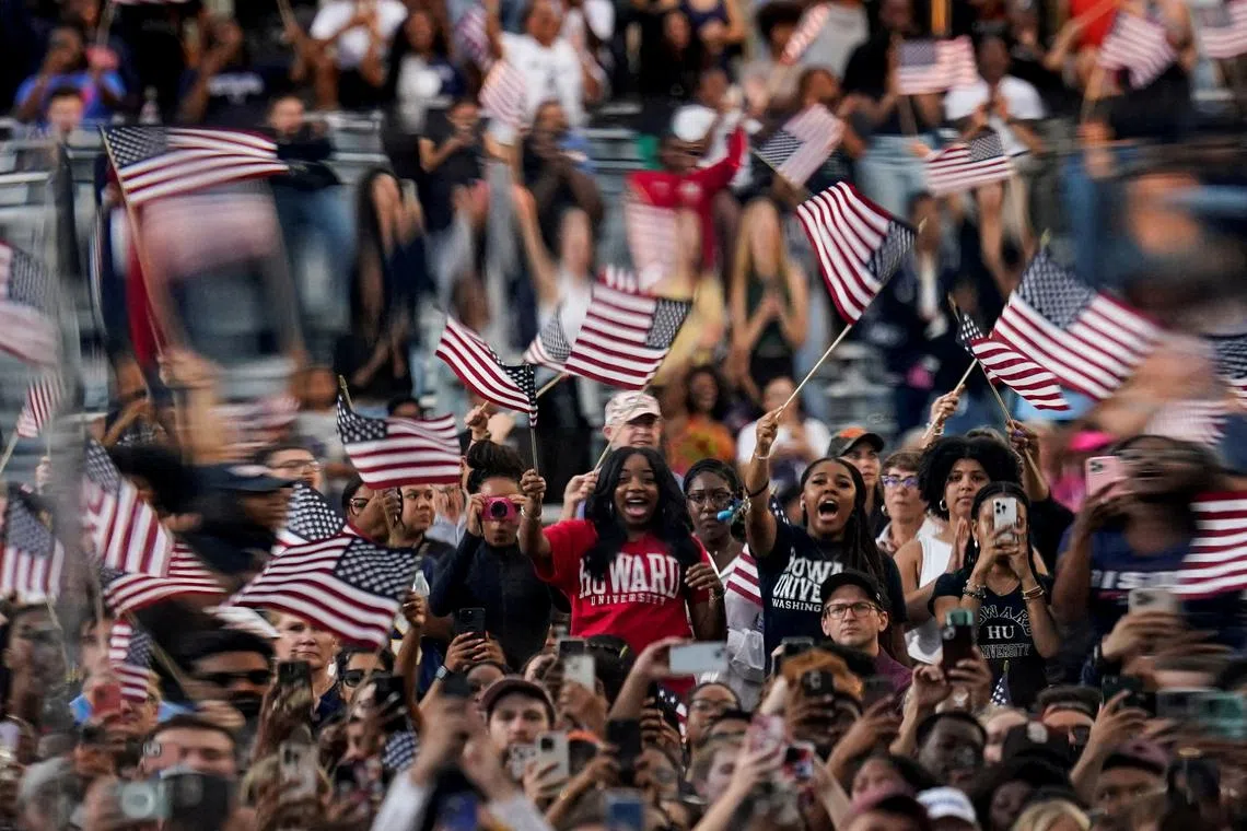 Supporters wave flags as Democratic presidential nominee Kamala Harris delivers remarks, conceding the election to Donald Trump, at Howard University on Nov 6.