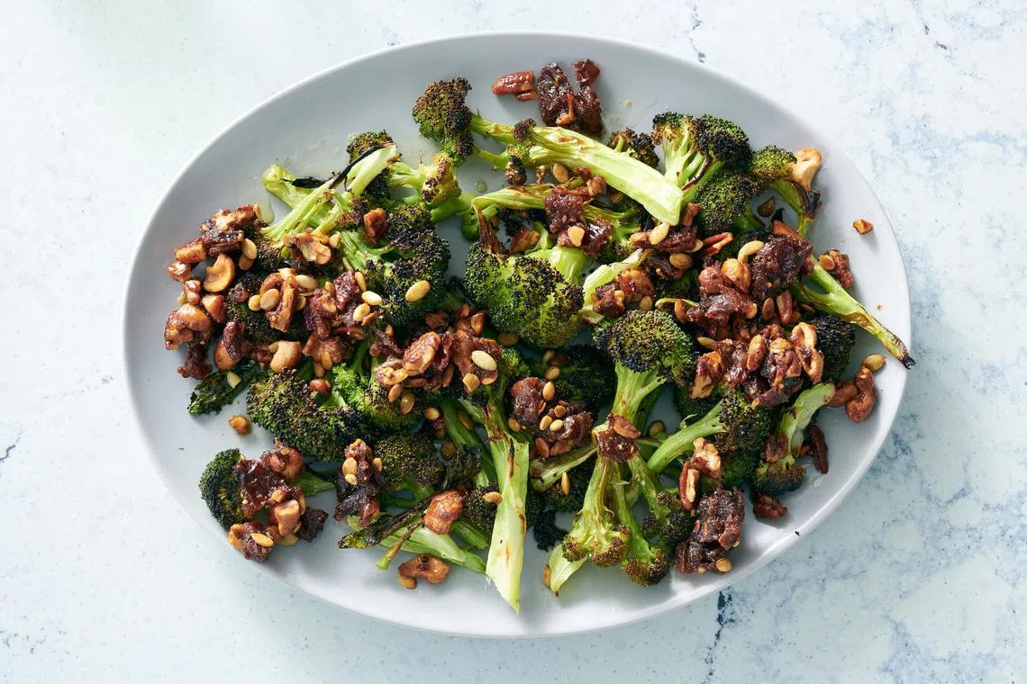 Broccoli with sizzled nuts and dates. Throwing a sheet pan of oiled broccoli in the broiler gives the vegetable a smoky char, which tastes especially good topped with crunchy nuts and caramelized dates. 