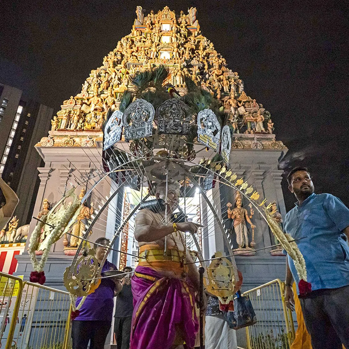 ST20250210_202594200751/BTTHAIPUSAM/Brian Teo/Mr Michael Lim, 50, who runs the Yu Feng Nam Fu Xuan Shan temple, leaving the Sri Srinivasa Perumal Temple in the wee hours of the morning on Feb 11, 2025, to embark on the 3.2km procession to Sri Thendayuthapani Temple in Tank Road during the Thaipusam festival. ST PHOTO: BRIAN TEO 