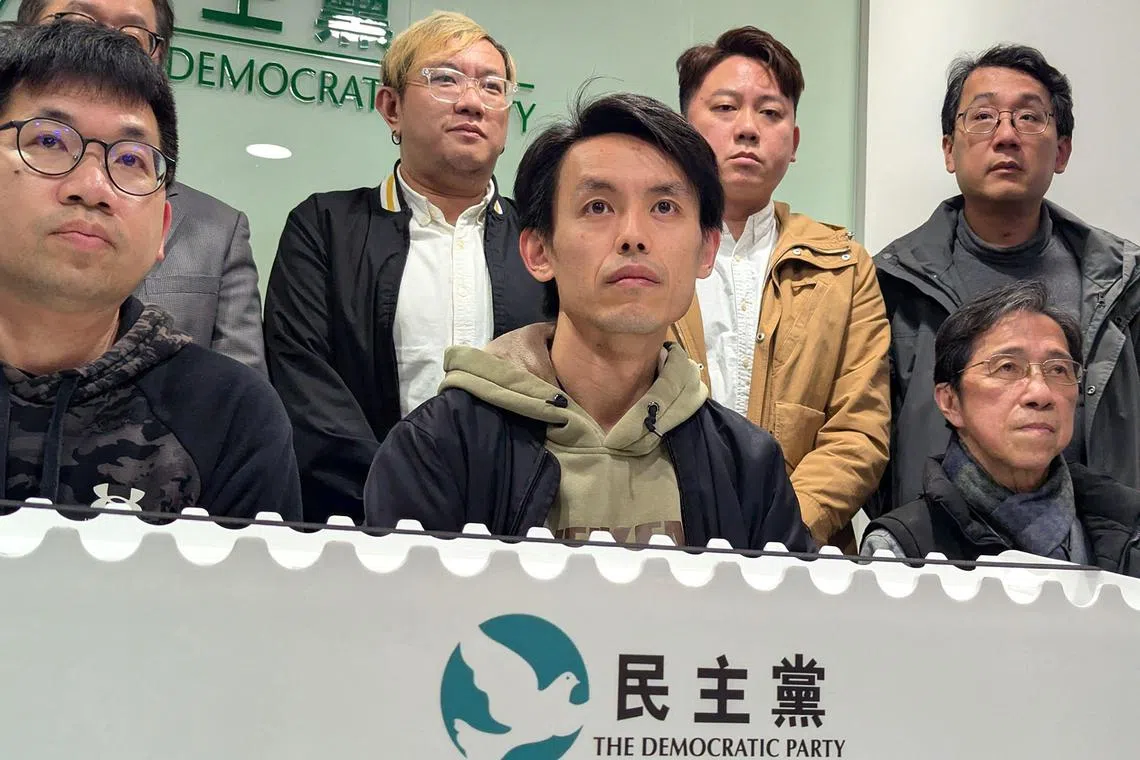 Lo Kin-hei (C), chairman of Hong Kong's Democratic Party, along with other senior leaders, attends a press conference at the party's headquarters in Hong Kong on February 20, 2025. A 30-year-old Hong Kong political party that used to lead the city's pro-democracy camp before Beijing cracked down on dissent will start preparations to wind down, its leader said on February 20. (Photo by Holmes CHAN / AFP)