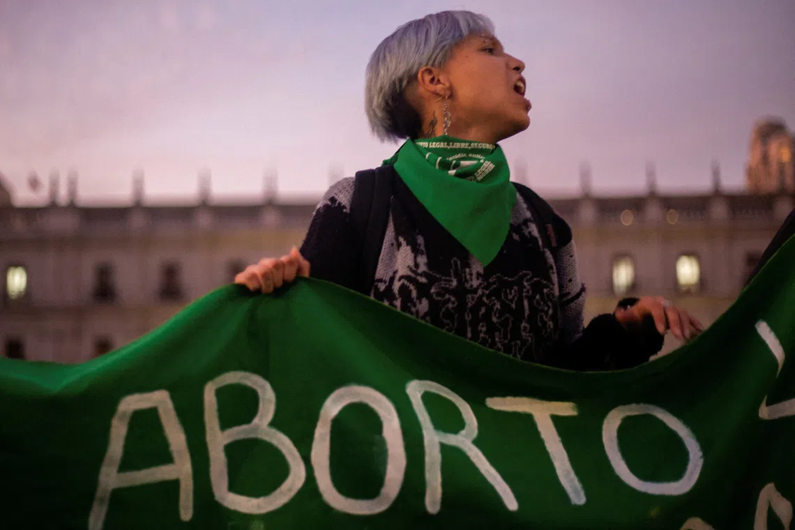 FILE PHOTO: A demonstrator holds a banner in a rally to mark International Safe Abortion Day, in front of La Moneda government palace, in Santiago, Chile, September 28, 2023. REUTERS/Quetzalli Nicte-Ha/File Photo/File Photo