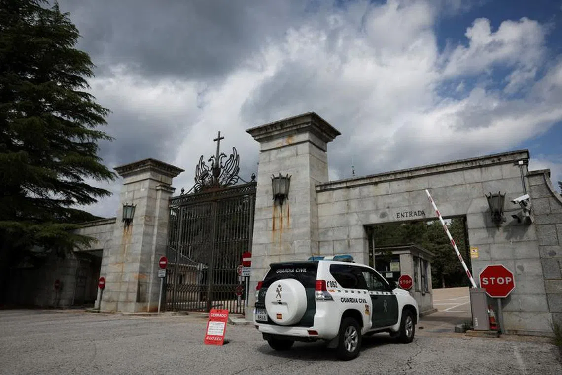 A police vehicle passes a sign informing visitors that the 'Valley of the Fallen' monument, now known as Valley of Cuelgamuros, is closed to the general public as forensic scientists begin work to remove the remains of 128 victims of the Spanish Civil War who are buried at the site, near Madrid, Spain, June 12, 2023. REUTERS/Violeta Santos Moura/File Photo
