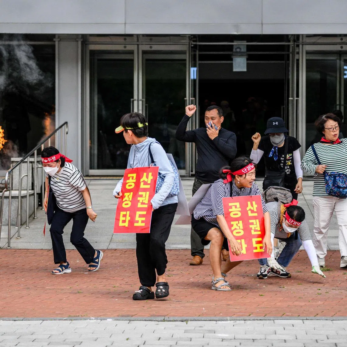 Mock protesters wearing placards that read ‘Destroy the communist regime’ take part in an anti-terror drill in Seoul. The incident serves as a reminder that in South Korea, jokes involving communism do not translate well.