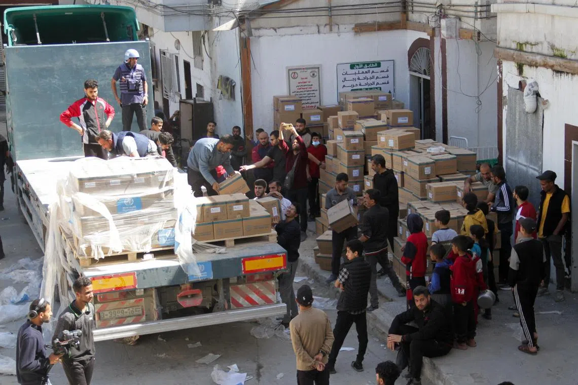 People unload medical aid from a truck, near Kamal Adwan Hospital in the northern Gaza Strip, on April 6, 2024. 
