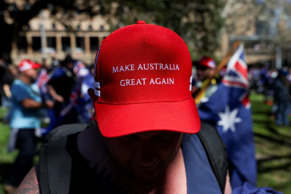 A demonstrator wearing a 'Make Australia Great Again' cap poses for a picture during the 'March for Australia' anti-immigration rally, in Sydney, Australia, August 31, 2025. REUTERS/Hollie Adams