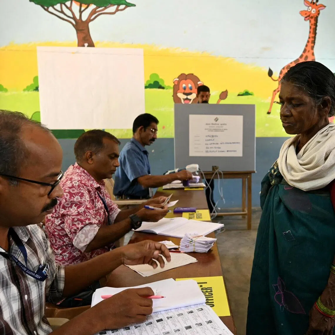A voter having her documents verified at a polling station during India's general election in Wayanad district, Kerala, on April 26, 2024.