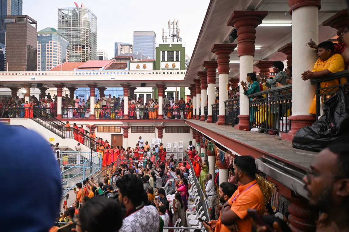 Visitors come to see an estimated 4,000 devotees walked barefoot across a pit of hot coals on Oct 12, as the annual fire-walking festival returned to the Sri Mariamman Temple. 