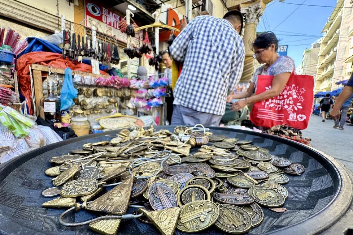 maletter - Medallions bearing the image of Saint Benedict, believed by Catholics to provide protection, are sold by one vendor in Quiapo, Manila alongside different talismans and amulets meant to ward off evil spirits.
ST PHOTO: MARA CEPEDA