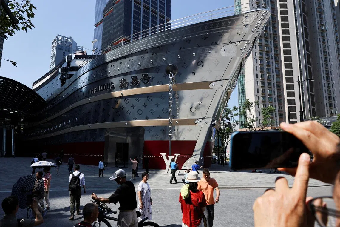 People taking photos of the new Louis Vuitton store in Shanghai, China, on June 27, 2025.