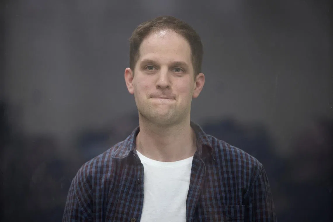 FILE PHOTO: Wall Street Journal reporter Evan Gershkovich, who is in custody on espionage charges, stands behind a glass wall of an enclosure for defendants during a court hearing in Moscow, Russia, April 23, 2024. REUTERS/Tatyana Makeyeva/File Photo