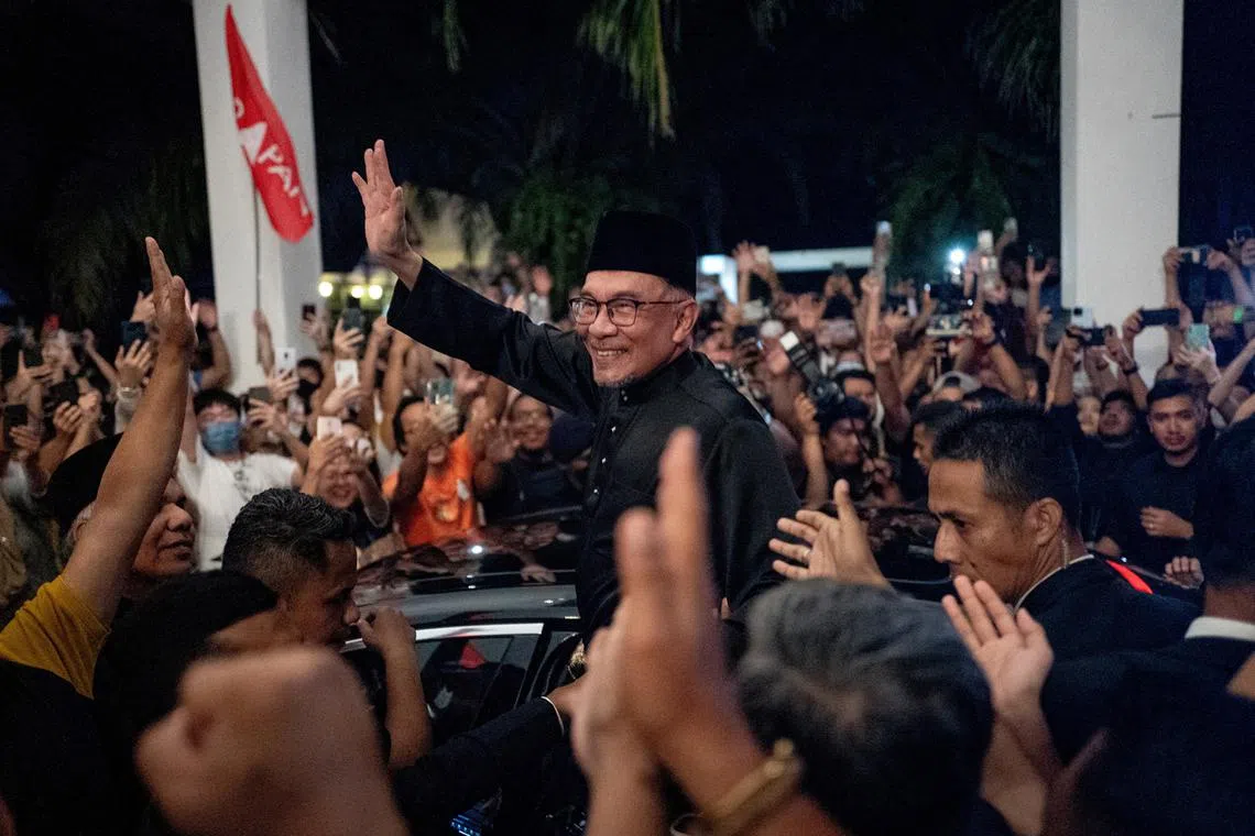 Malaysia's newly appointed Prime Minister Anwar Ibrahim waves to his supporters after his news conference in Sungai Long, Selangor, Malaysia Nov 24, 2022. 
