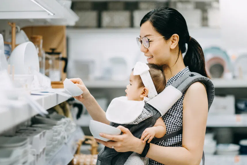Asian mum shopping with baby in baby carrier